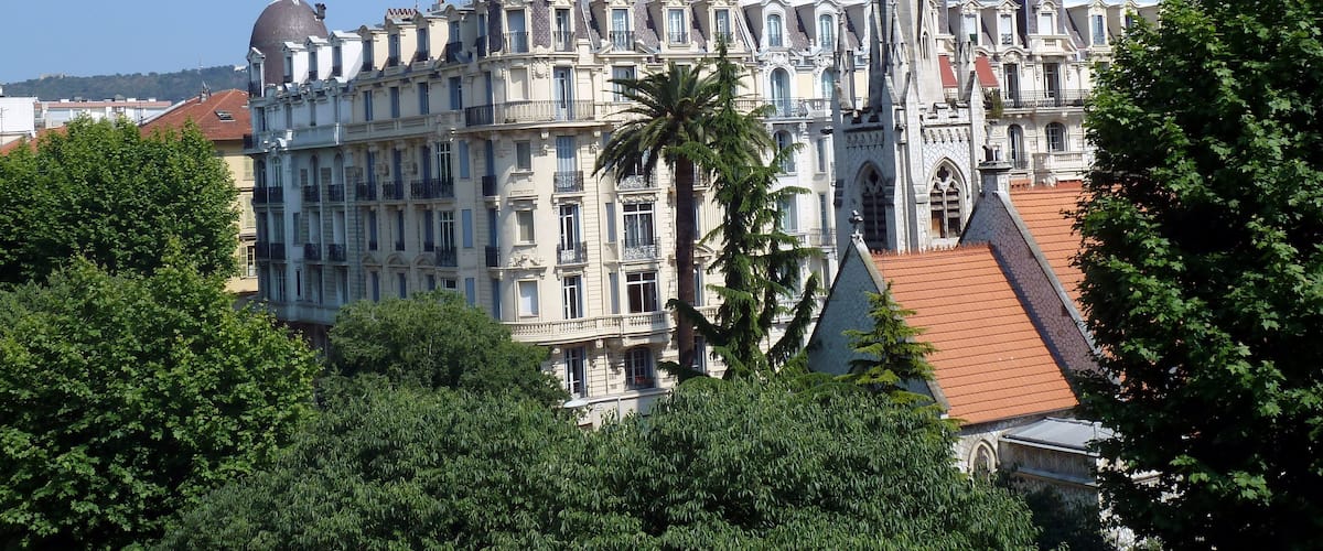 The spire of protestant church in Nice. In the background Hotel La Villa Victor Hugo, Boulevard Victor Hugo.