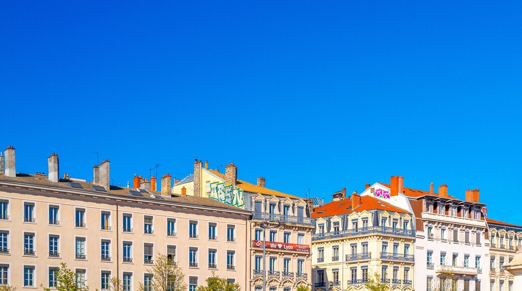Lyon city skyline and an equestrian statue of King Louis XIV, at the Place Bellecour plaza, the largest pedestrian square in Europe, and a UNESCO World Heritage Site, in France