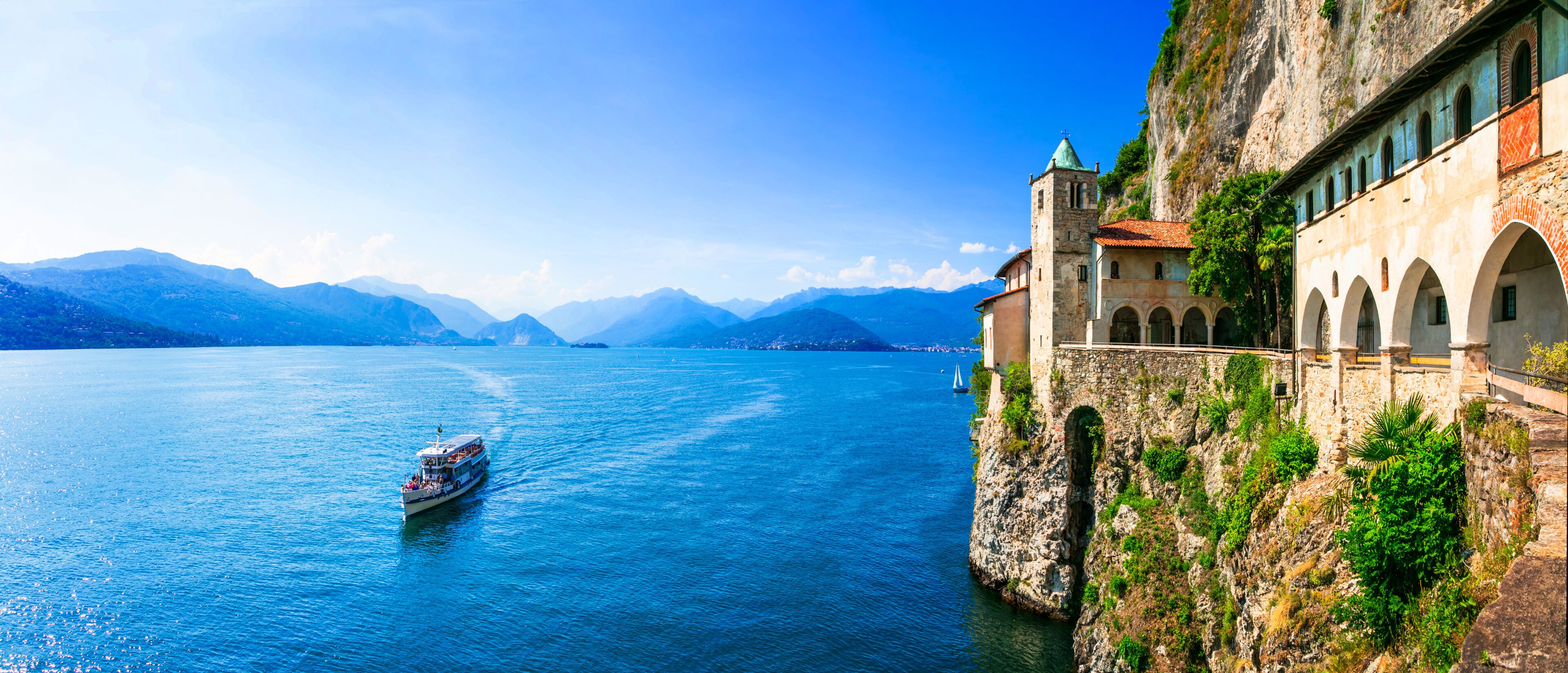 Ultra Wide Panorama of Eremo di Santa Caterina del Sasso — Medieval Monastery Built into Rock Cliff Overlooking Lake Maggiore, Lombardy Italy
