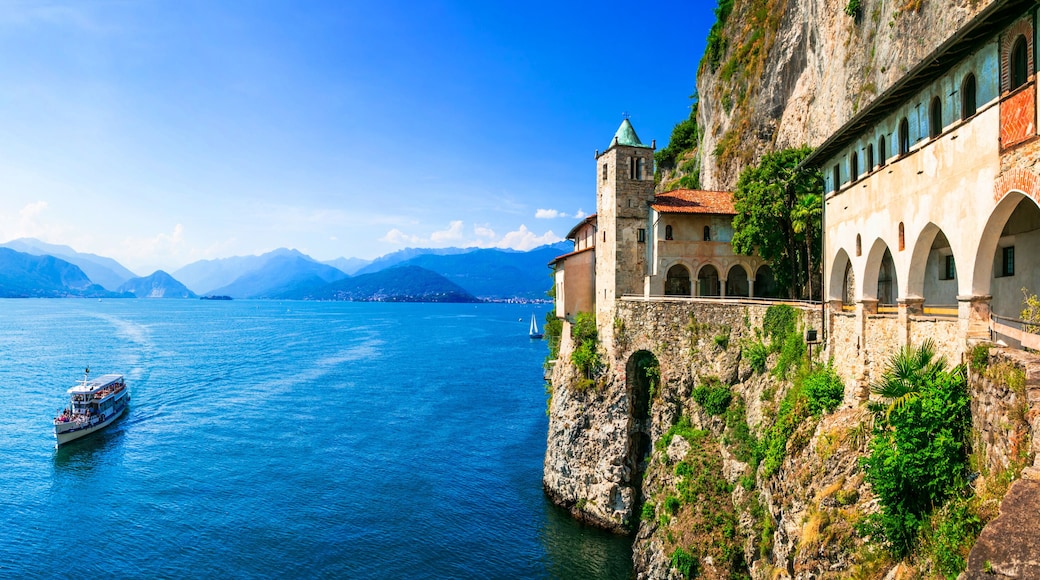 Ultra Wide Panorama of Eremo di Santa Caterina del Sasso — Medieval Monastery Built into Rock Cliff Overlooking Lake Maggiore, Lombardy Italy