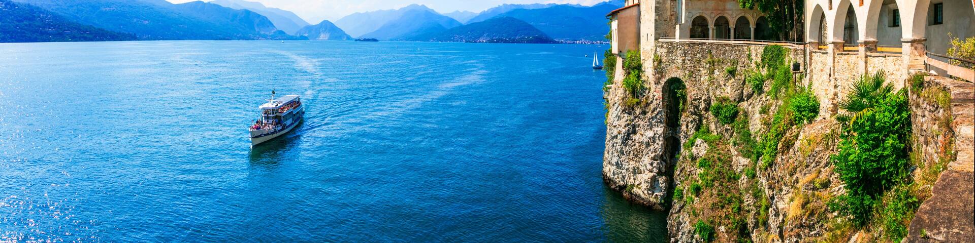 Ultra Wide Panorama of Eremo di Santa Caterina del Sasso — Medieval Monastery Built into Rock Cliff Overlooking Lake Maggiore, Lombardy Italy