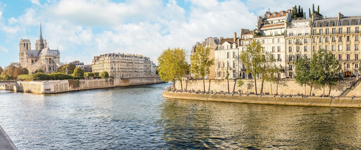 The Seine river and the Apse of Notre Dame Cathedral, located on the eastern end of Ile de la Cite (City Island), on a sunny, summer day in Paris, France.