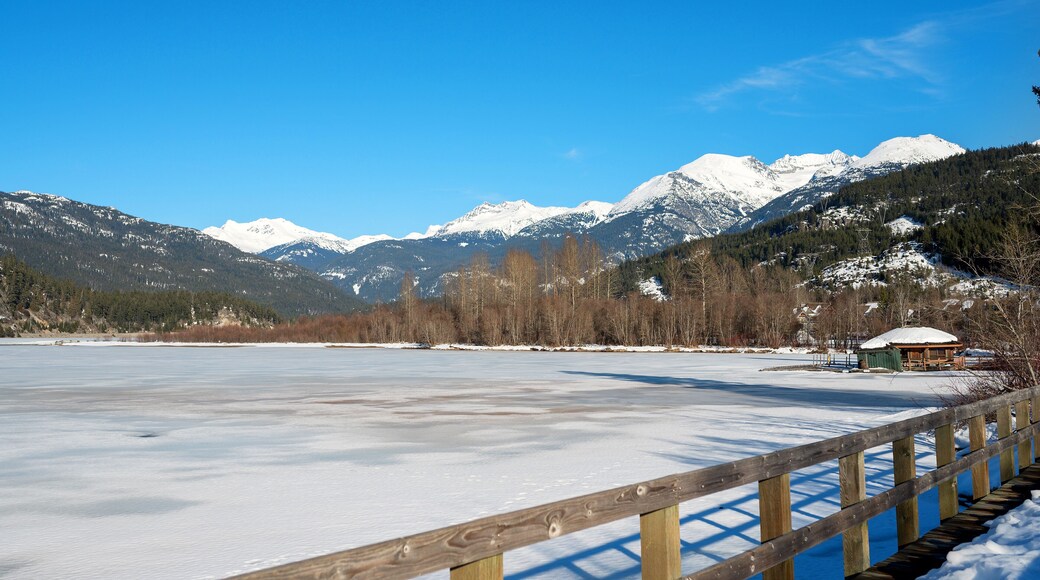 A frozen mountain lake in British Columbia, Canada. Green Lake Nicklaus North Golf Course in winter. Whistler BC, Canada.