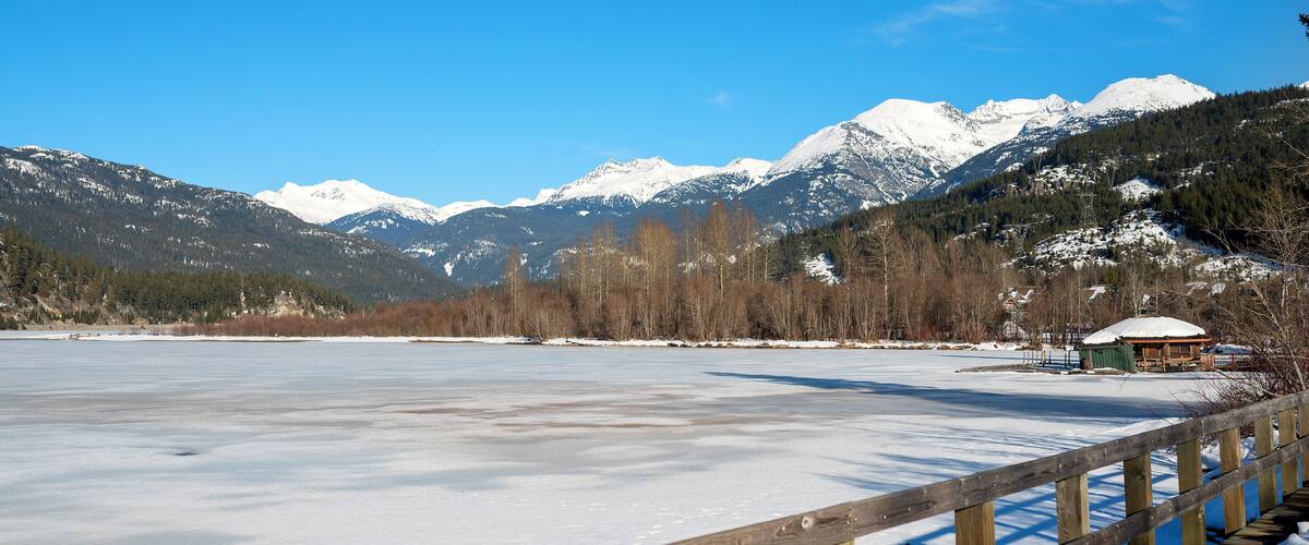 A frozen mountain lake in British Columbia, Canada. Green Lake Nicklaus North Golf Course in winter. Whistler BC, Canada.