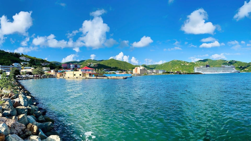 Overlooking the Road Harbor in Road Town, located on Tortola. A cruise ship docked on the port terminal. Road Town is the capital of the British Virgin Islands, on Caribbean Sea. Panoramic view. BVI