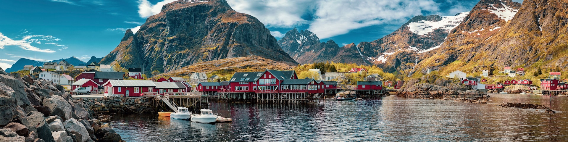 Panoramic shot of A village, Moskenes, on the Lofoten in northern Norway. Norwegian fishing village, with the typical rorbu houses. Mountain In Background