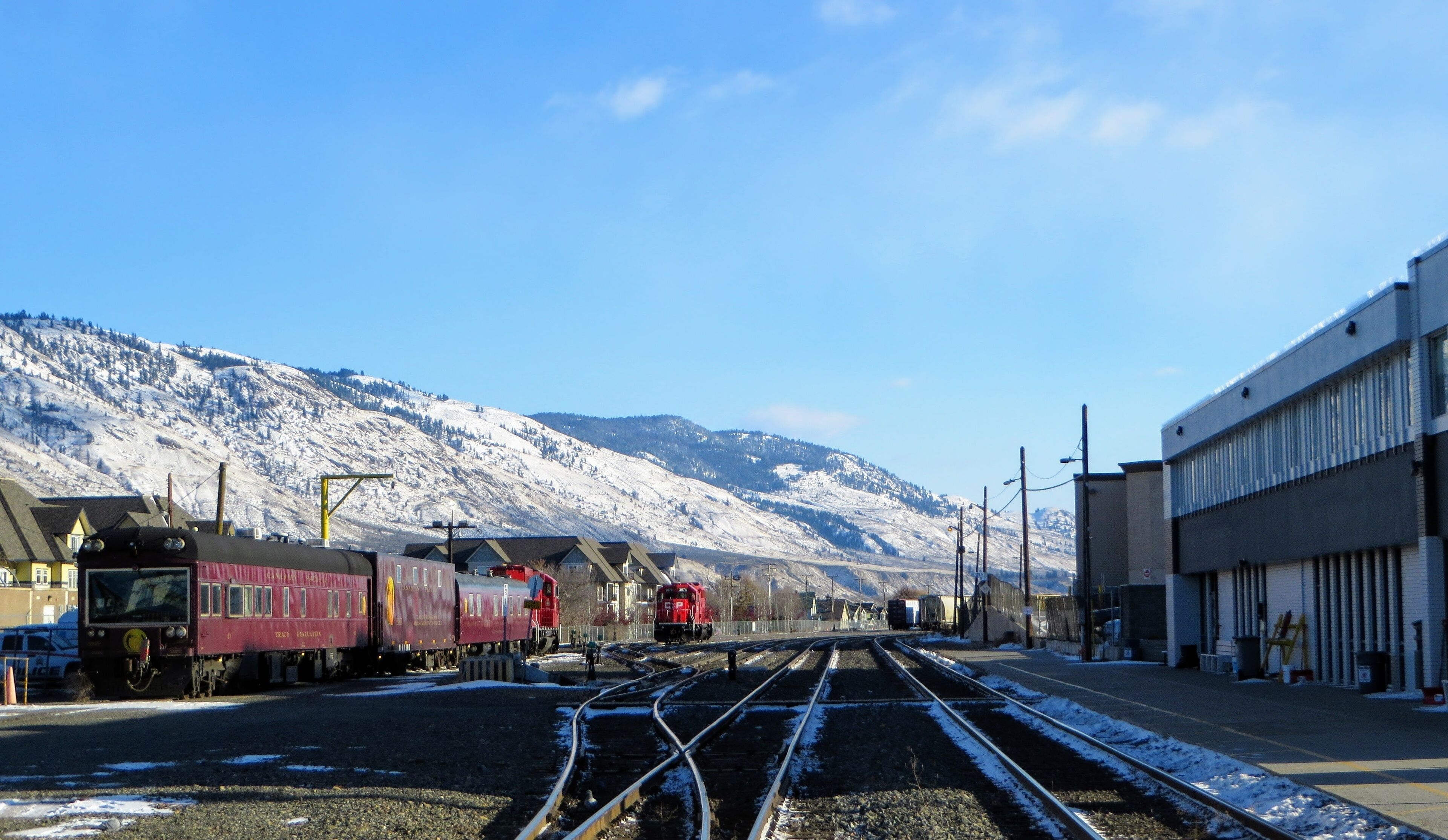 The Canadian Pacific Railway train stopped in downtown Kamloops, British Columbia, Canada on a beautiful winters day with sunshine and blue sky.