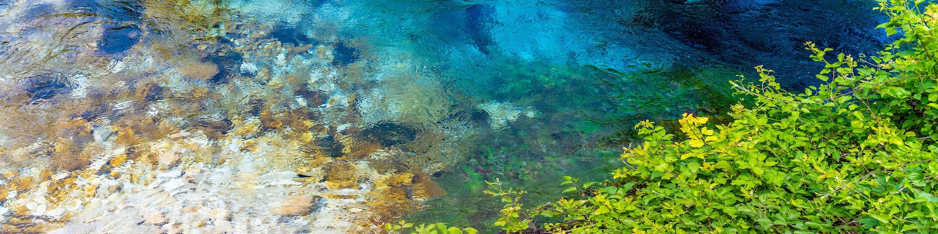 A panorama aerial view across the pool fed by the Blue eye spring in Muzine, Albania in summertime