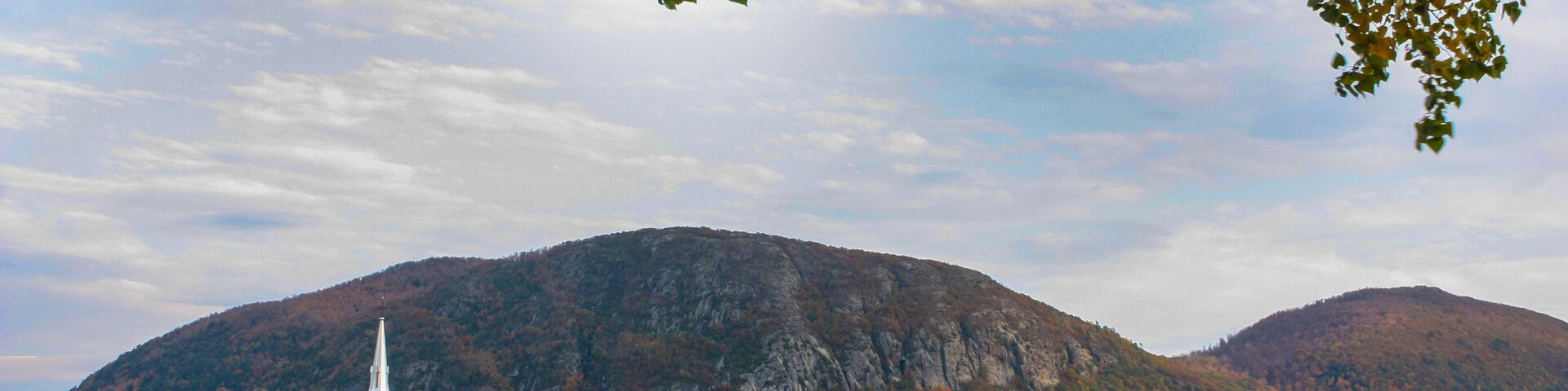 cityscape of st-hilaire with mountains behind and the richelieu river in front