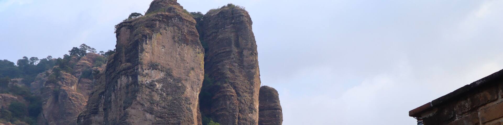 A rocky mountain with two prominent rock formations.