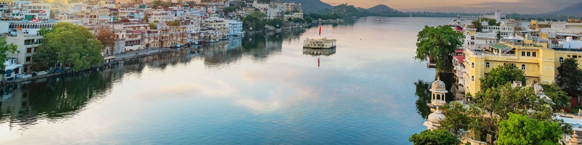 Udaipur city at lake Pichola in the morning, Rajasthan, India. View of City palace reflected on the lake.