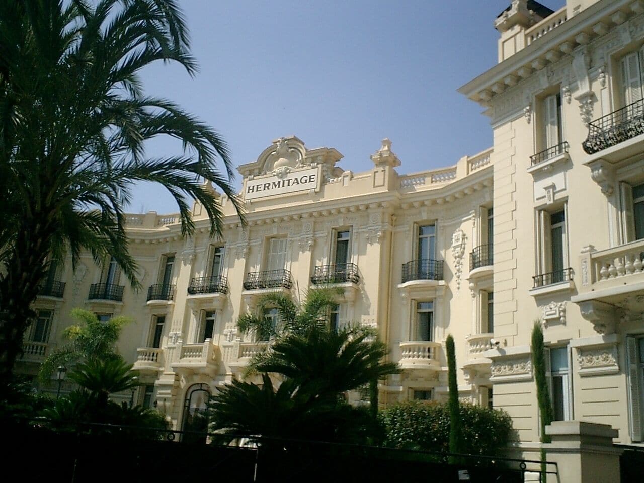 A classical building with the sign "HERMITAGE" and ornate balconies.