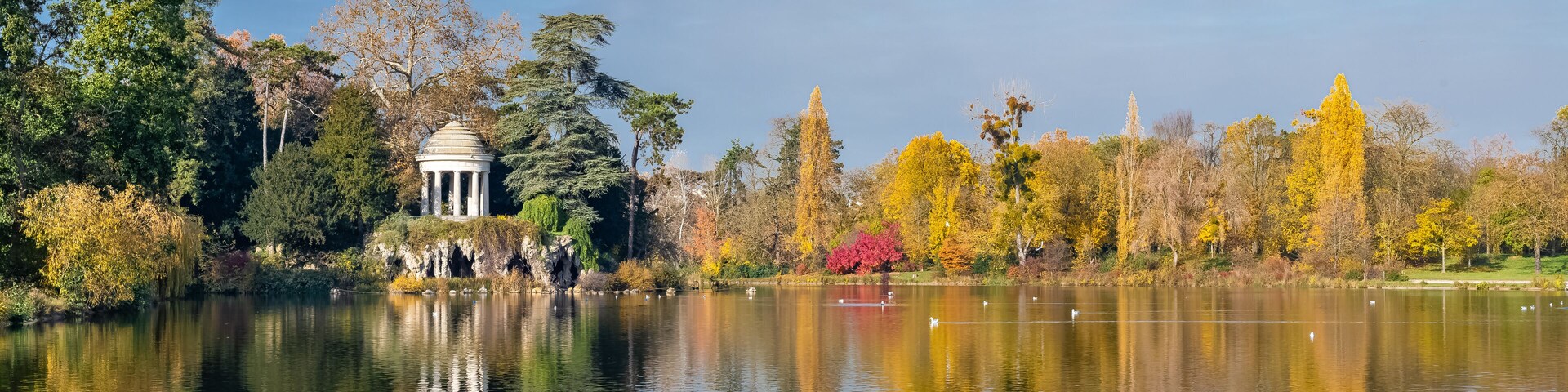 Vincennes, the temple of love and artificial grotto on the Daumesnil lake, in the public park, in autumn