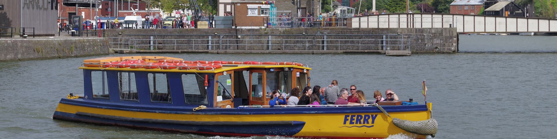 A ferry on the waters of Bristol Docks, coming out of St Augustine's Reach and heading west.