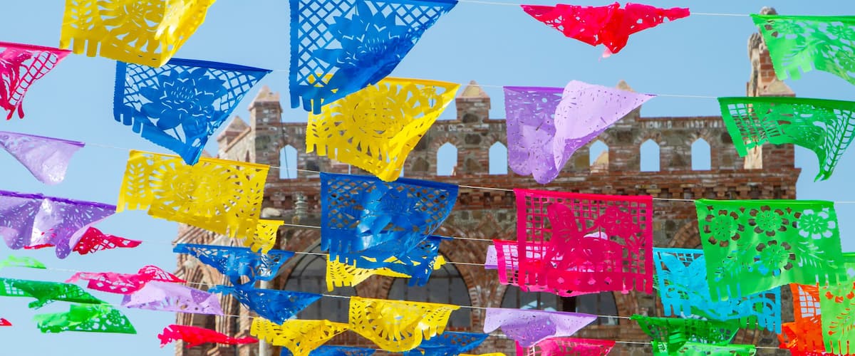 Colorful festive flags hanging at a brick outdoor location in Rosarito Mexico