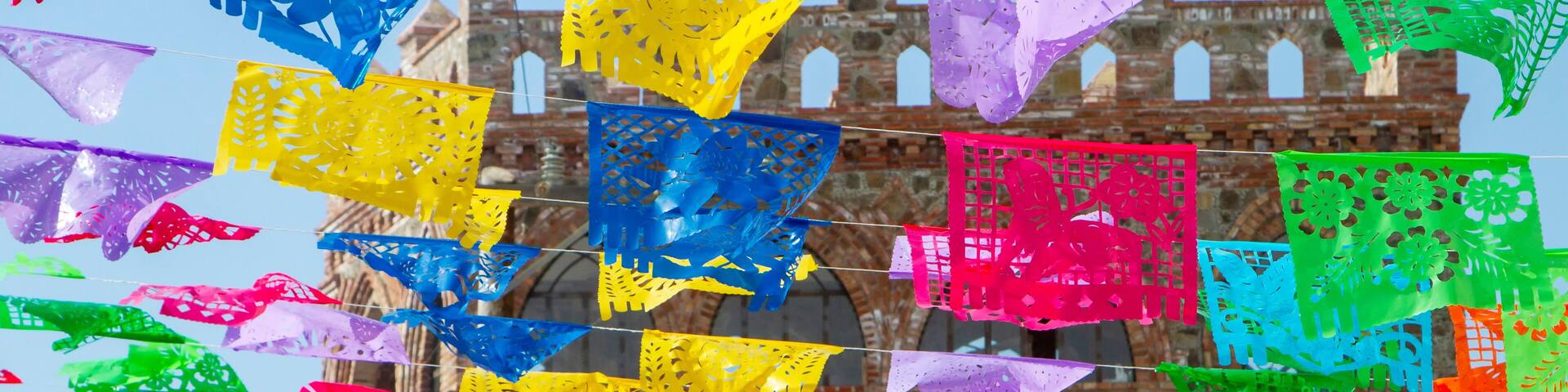 Colorful festive flags hanging at a brick outdoor location in Rosarito Mexico