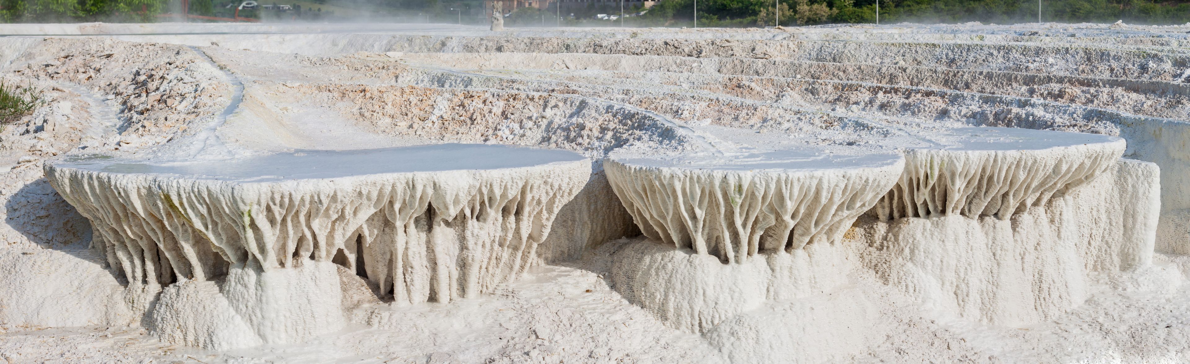 Panorama photo of limestone hill created by water runoff