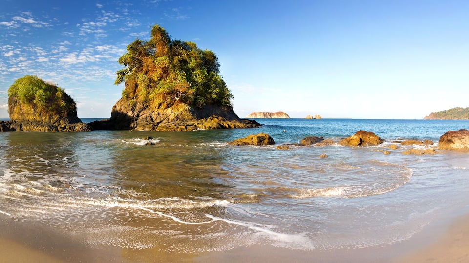 Wide Panoramic Landscape of Pacific Ocean Coastline and Small Islands on Manuel Antonio National Park Playa Espadilla Beach in Costa Rica
