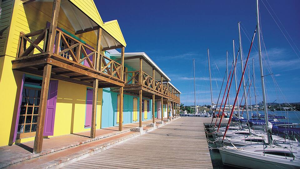Colorful buildings facing docked boats in marina