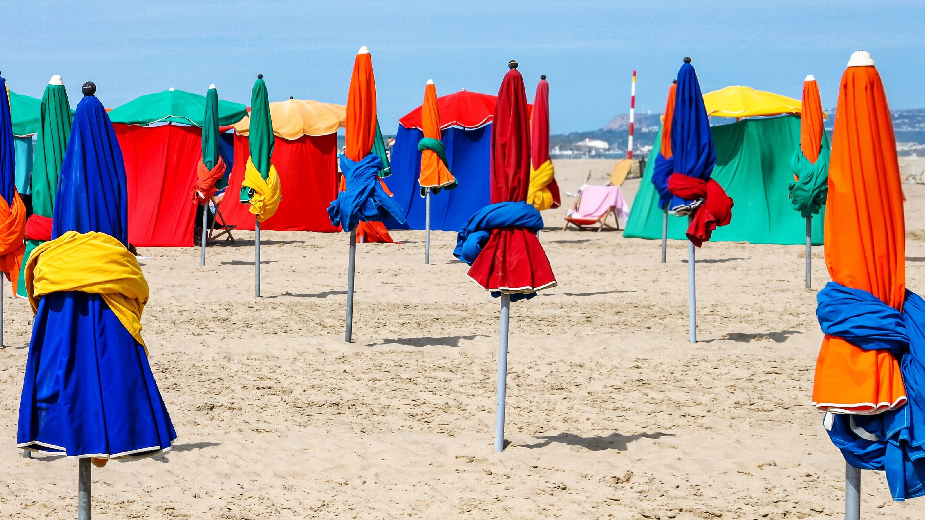 Colorful Beach Umbrellas on Normandy Coast with Copy Space