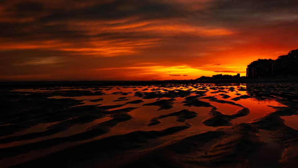 Golden red sunset reflected along the beach in Puerto Penasco, Mexico