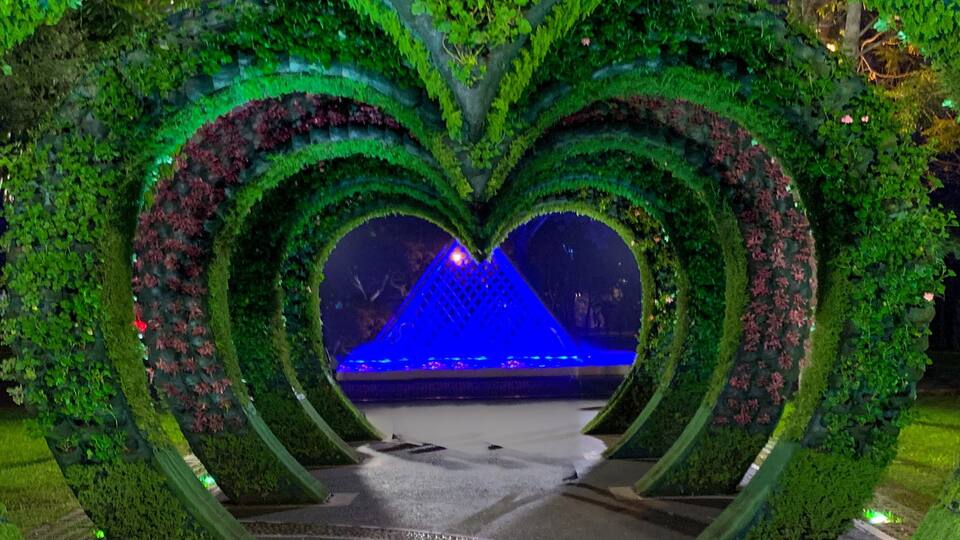 Another colorful pyramid shaped water fountain beyond the heart shaped canopies at the Parque De La Reserva in central Lima.