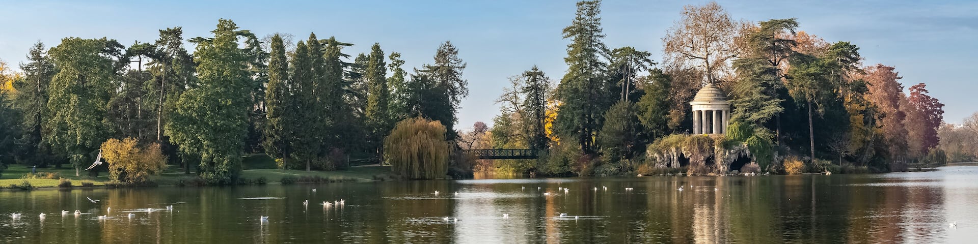 Vincennes, the temple of love and artificial grotto on the Daumesnil lake, in the public park, in autumn