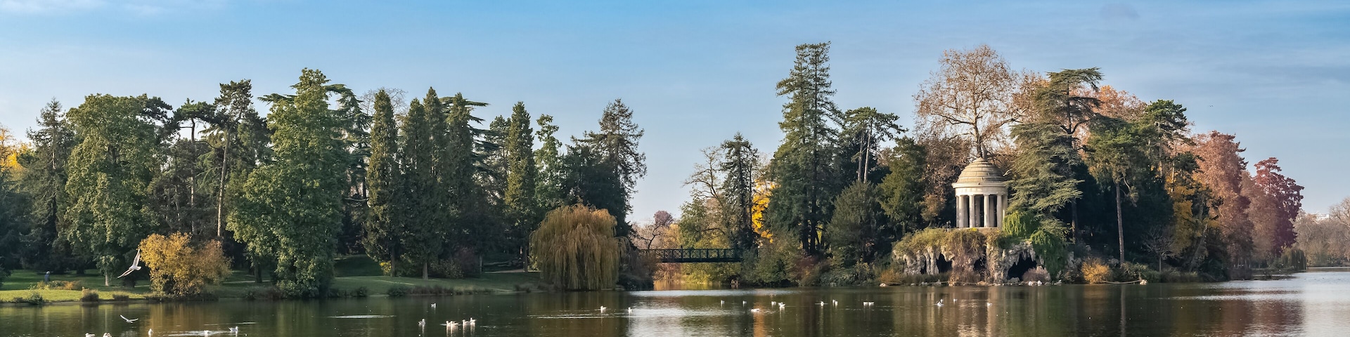 Vincennes, the temple of love and artificial grotto on the Daumesnil lake, in the public park, in autumn