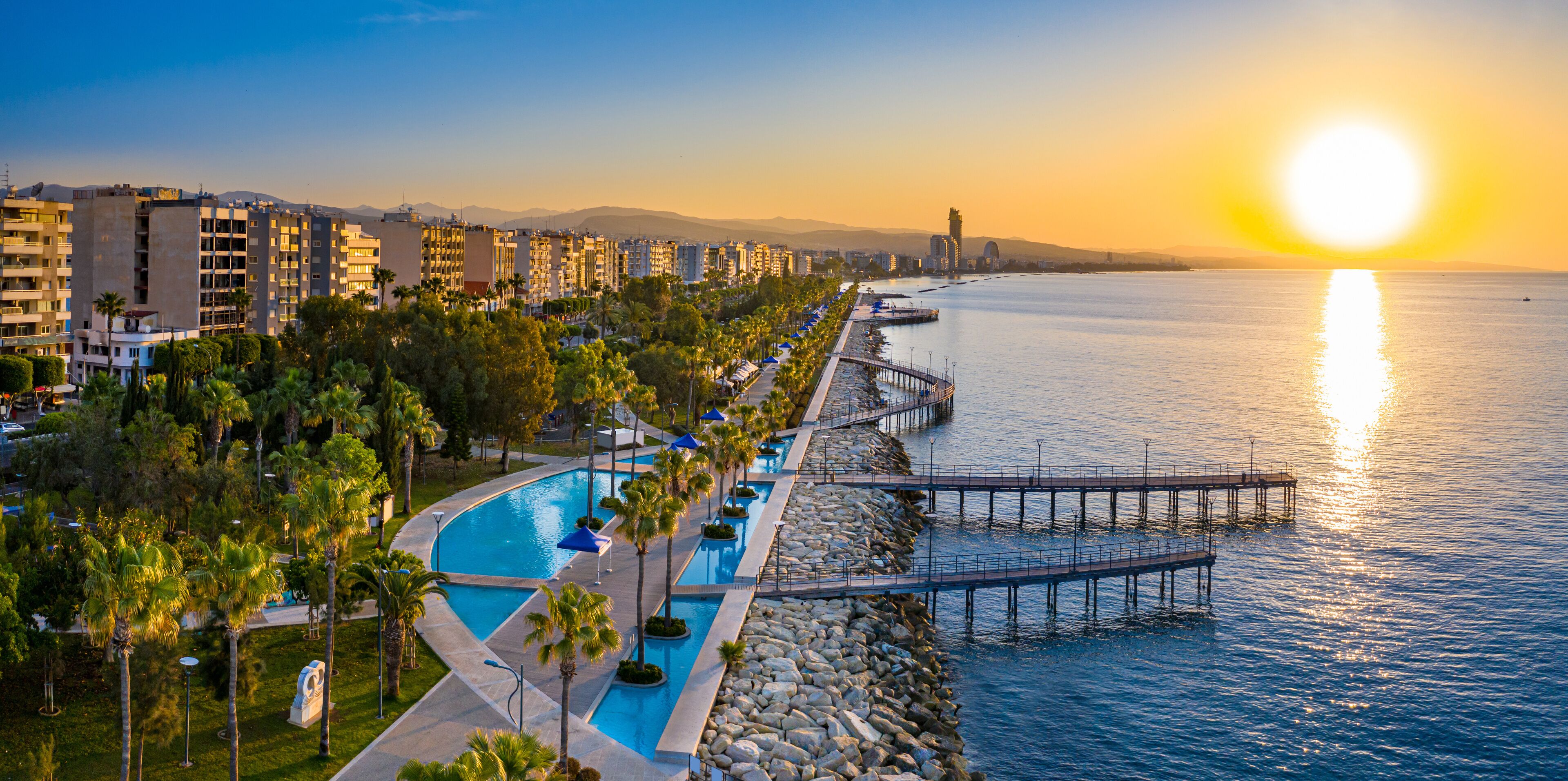 Republic of Cyprus. Limassol. Sunrise over the Mediterranean sea. The Seafront Of Limassol. Walking area with sea view. Early morning in Cyprus. The sun rises over the sea. Promenade.