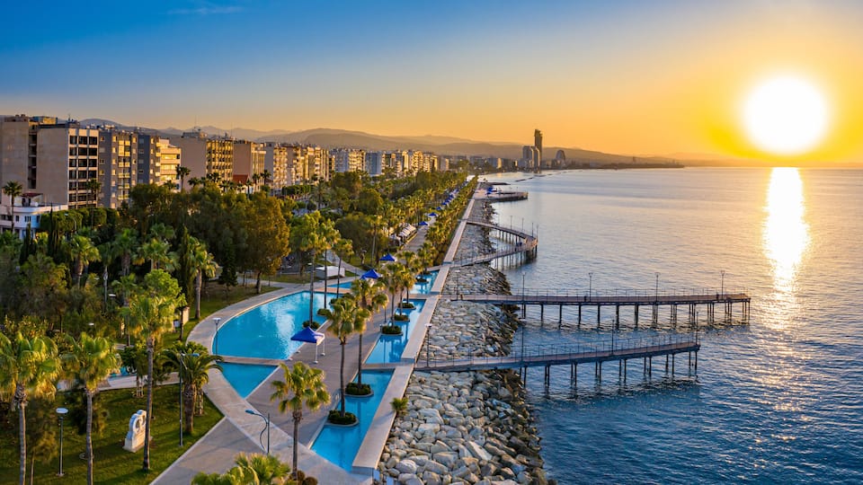 Republic of Cyprus. Limassol. Sunrise over the Mediterranean sea. The Seafront Of Limassol. Walking area with sea view. Early morning in Cyprus. The sun rises over the sea. Promenade.