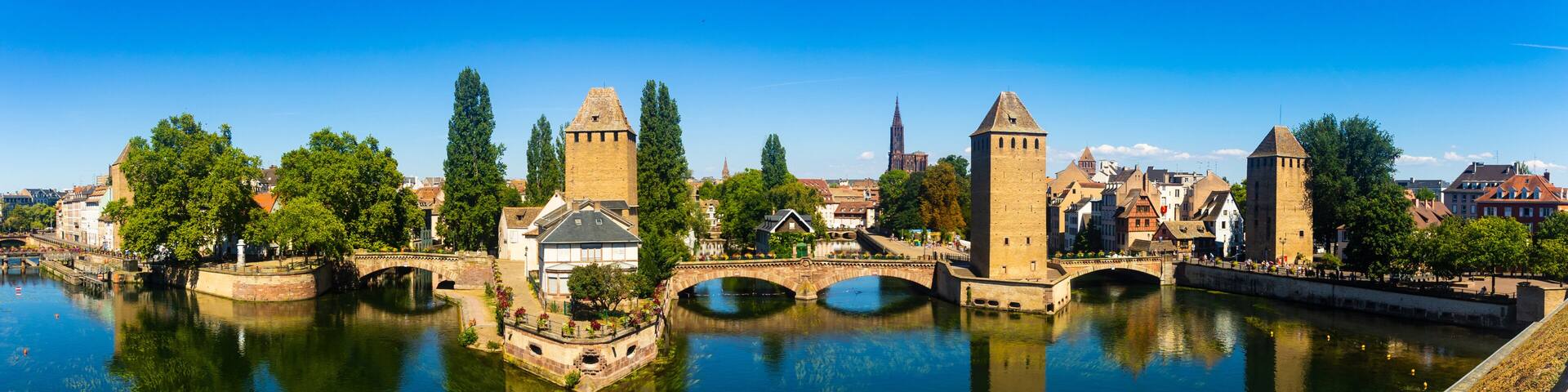 A river with bridges, historic buildings, and towers.