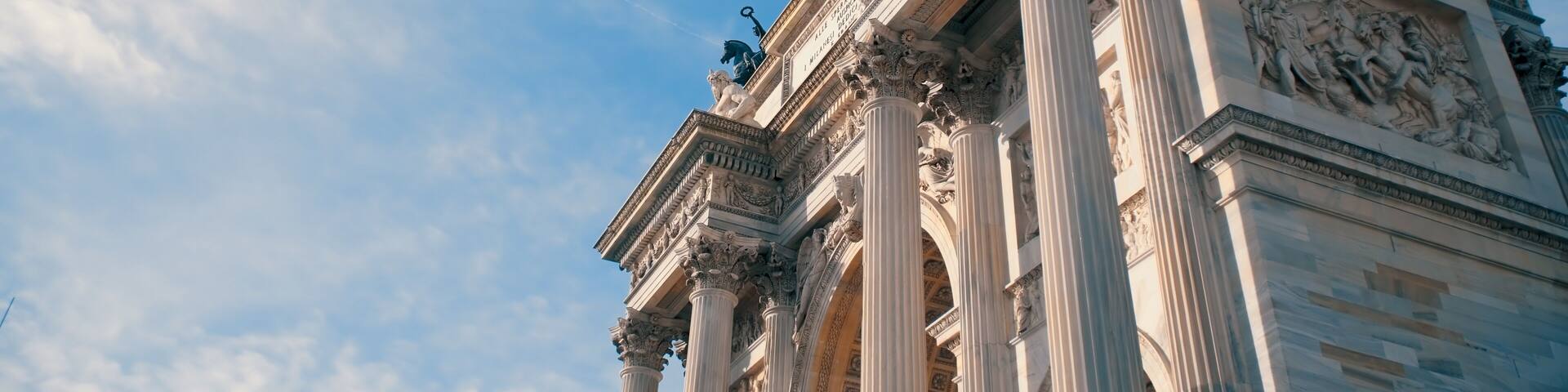 A classical building with ornate columns and statues.