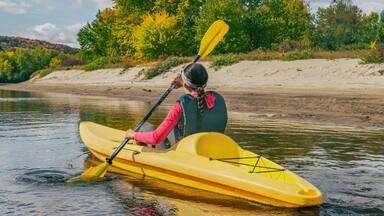 Kayak on river in Laurentians, Quebec .Canada travel destination banner. Woman kayaker kayaking down the river in Mont-Tremblant.