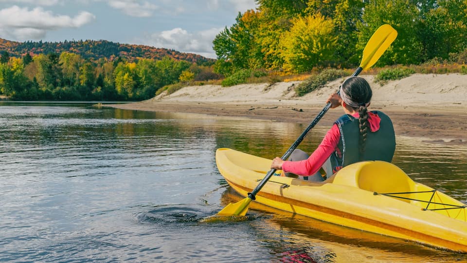 Kayak on river in Laurentians, Quebec .Canada travel destination banner. Woman kayaker kayaking down the river in Mont-Tremblant.