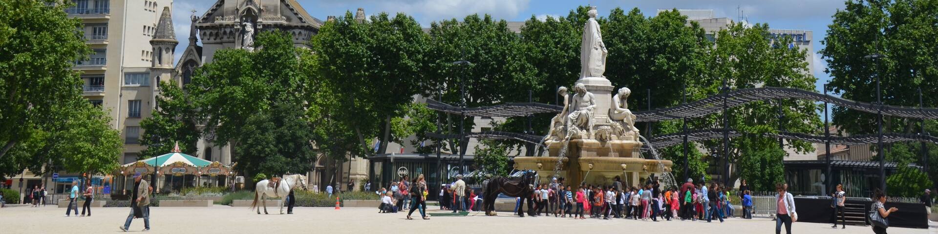 The big central square of Nimes with churchtower