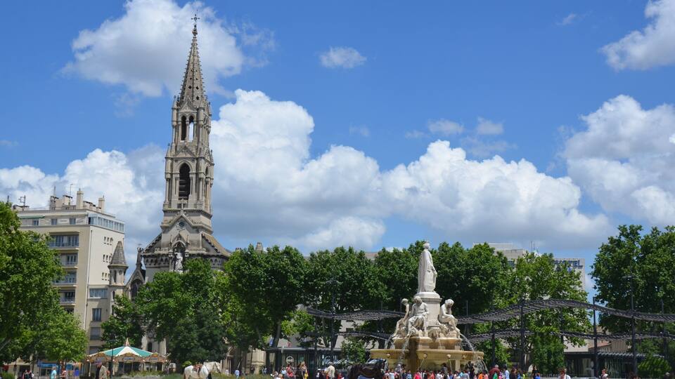 The big central square of Nimes with churchtower