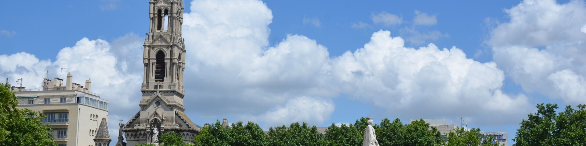 The big central square of Nimes with churchtower