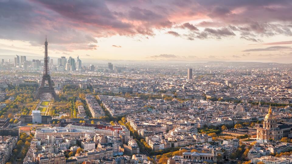 A panoramic view of Paris, including the Eiffel Tower, the Louvre, and the cityscape.