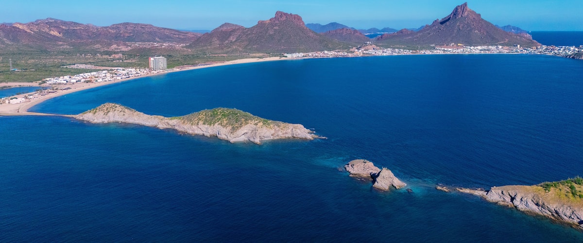 Aerial photo of Los Algodones beach in San Carlos Sonora, Mexico. The islands full of sahuaros stand out. An iconic contrast between desert and sea. In the background the rocky mountain Tetakawi.