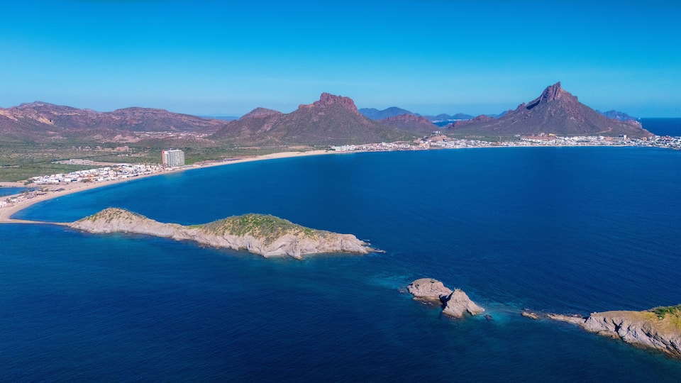 Aerial photo of Los Algodones beach in San Carlos Sonora, Mexico. The islands full of sahuaros stand out. An iconic contrast between desert and sea. In the background the rocky mountain Tetakawi.
