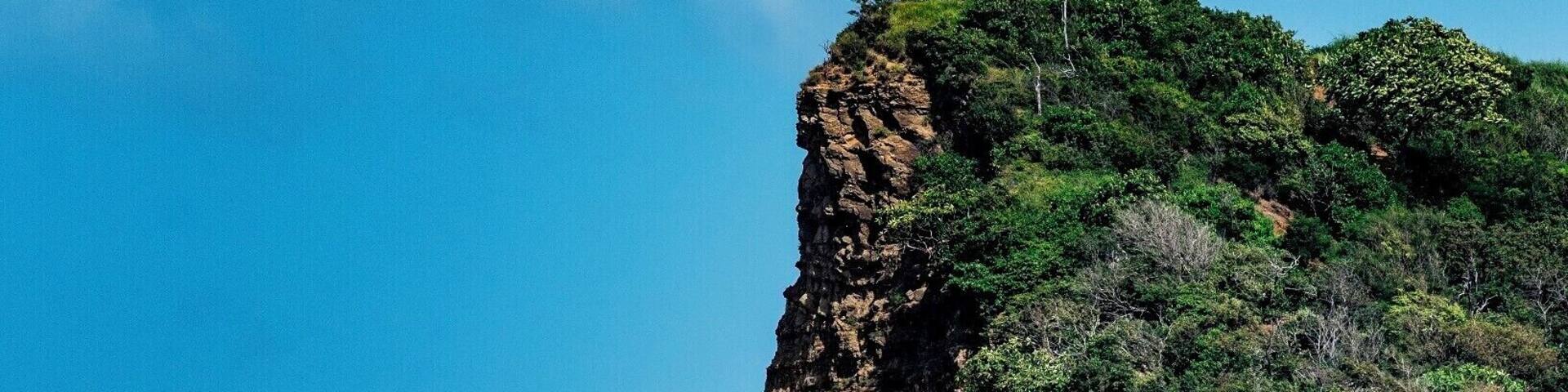 Lush green headland and inviting ocean on this beautiful beach. #BeachBound #beachtips