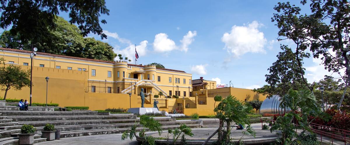 National Museum of Costa Rica in an old military barracks, with the Costa Rican flag flying above it, in downtown San Jose, Costa Rica