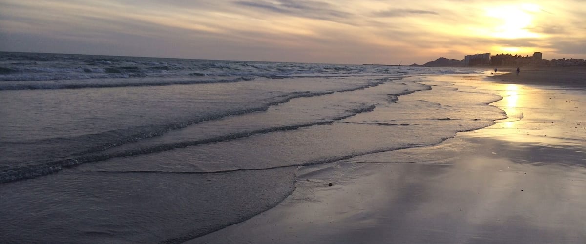 The essence of life is watching the sunset while walking on the beach.