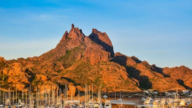 A mountainous landscape with a marina filled with boats.