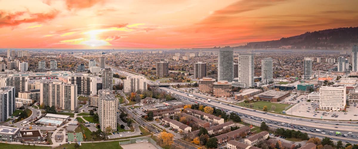 Don Valley Parkway with orange red skies at sunset with the don valley parkway at rush hour in the fall