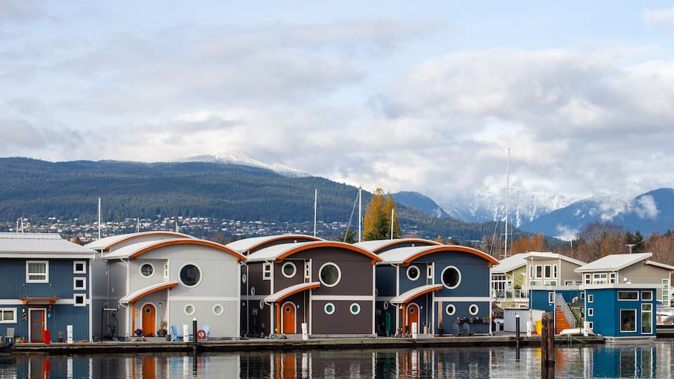 Cute, colourful floating houseboats line the docks in Mosquito Creek Marina, North Vancouver, British-Columbia. This alternative housing is growing in popularity with a challenging housing market.