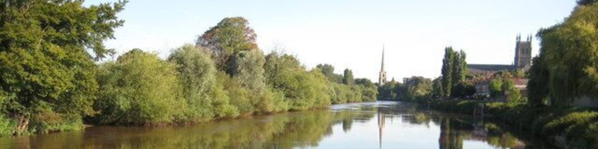 The River Severn at Diglis View up the River Severn from where the Worcester and Birmingham Canal enters the Severn at Diglis. Worcester Cathedral can be seen on the right and St Andrew's Spire is reflected in the calm waters of the river.