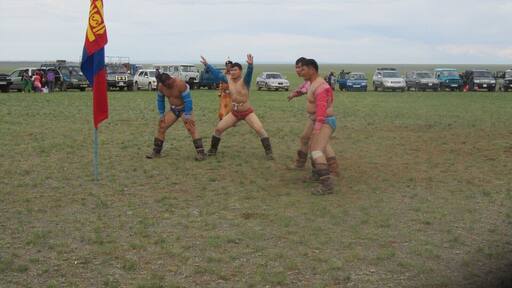 After a wrestling match the victors perform the eagle dance around the flag. We were lucky enough to go to a very small nadaam while we were in the Gobi Desert. The nadaam has wrestling, archery and a cross-country horse race. #Gobi Desert