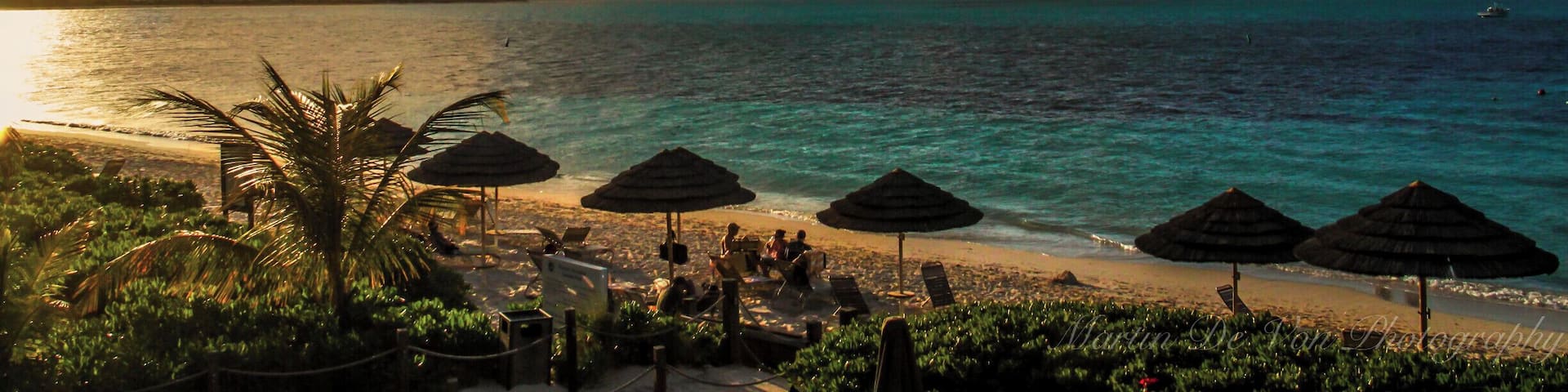 Grace Bay which features the famous 12-mile Grace Bay beach is the location for most of the tourism infrastructure, the Princess Alexandra Marine Park, which is also the playground of "Jo Jo" the famous bottlenose dolphin. Visitors to the world's first Conch Farm discover how to grow conch from tiny veligers to four-year-old adults. This is where most of the water sport activities take place from diving to deep sea fishing and everything in between.
Stones engraved by shipwrecked sailors (or waiting ship wreckers) can be found on the hilltop overlooking the now abandoned Marina Inn near Chalk Sound and Sapodilla Bay. If you like old ruins that are not too difficult to get to, visit 2 sites of plantation houses built by Loyalists, Cheshire Hall and Richmond Hill. "The Hole" at Long Bay is a deep and wide Limestone chimney with a mysterious depth of salt water at the bottom.