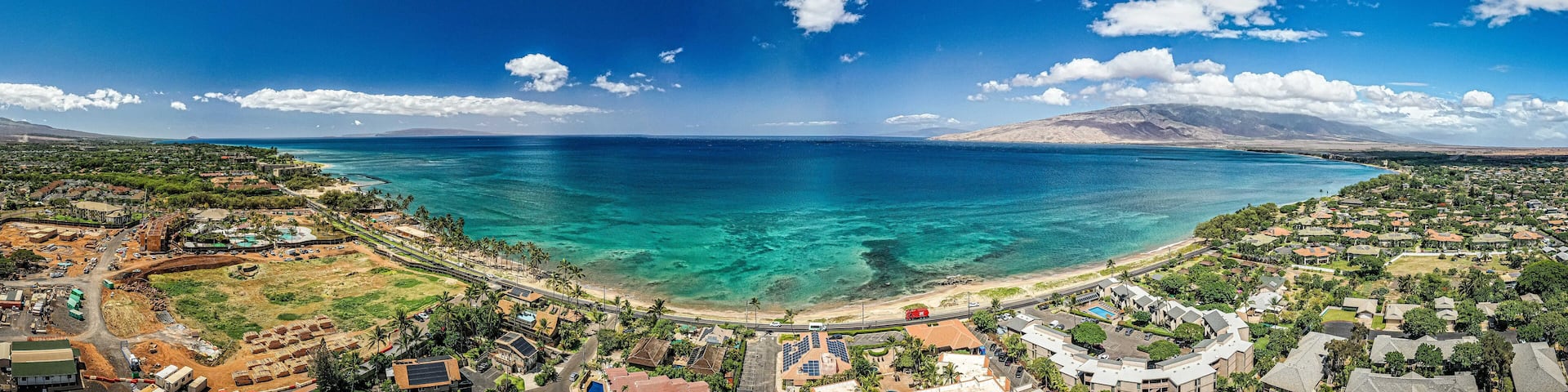 Panoramic perspective view into Teal water from beautiful Hawaiian Island of Maui with white sand beach in Kihei
